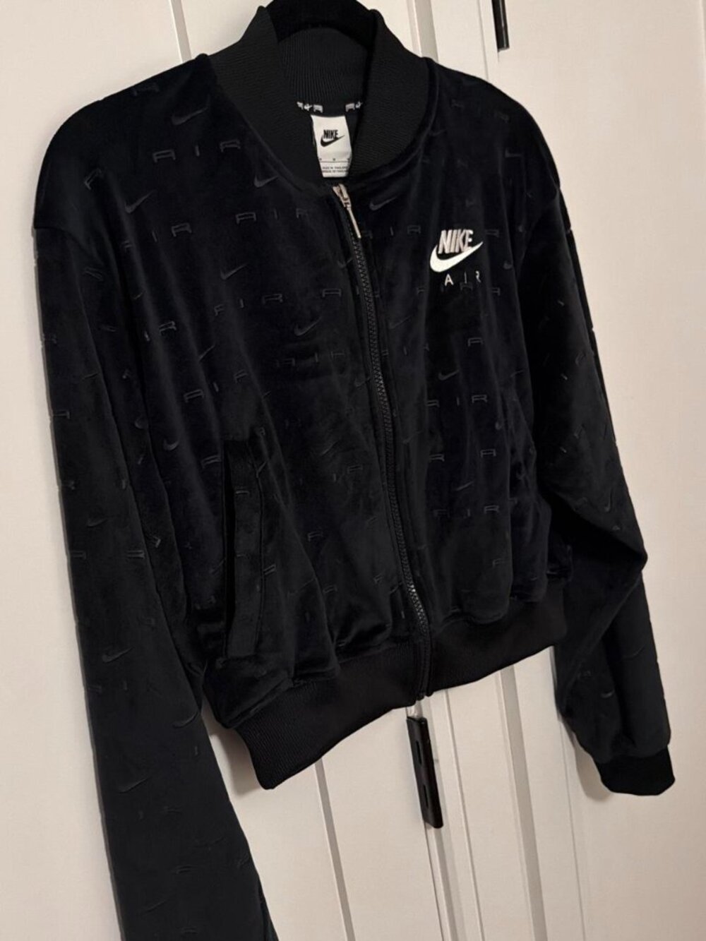 Nike Air black bomber jacket with repeating AIR text pattern